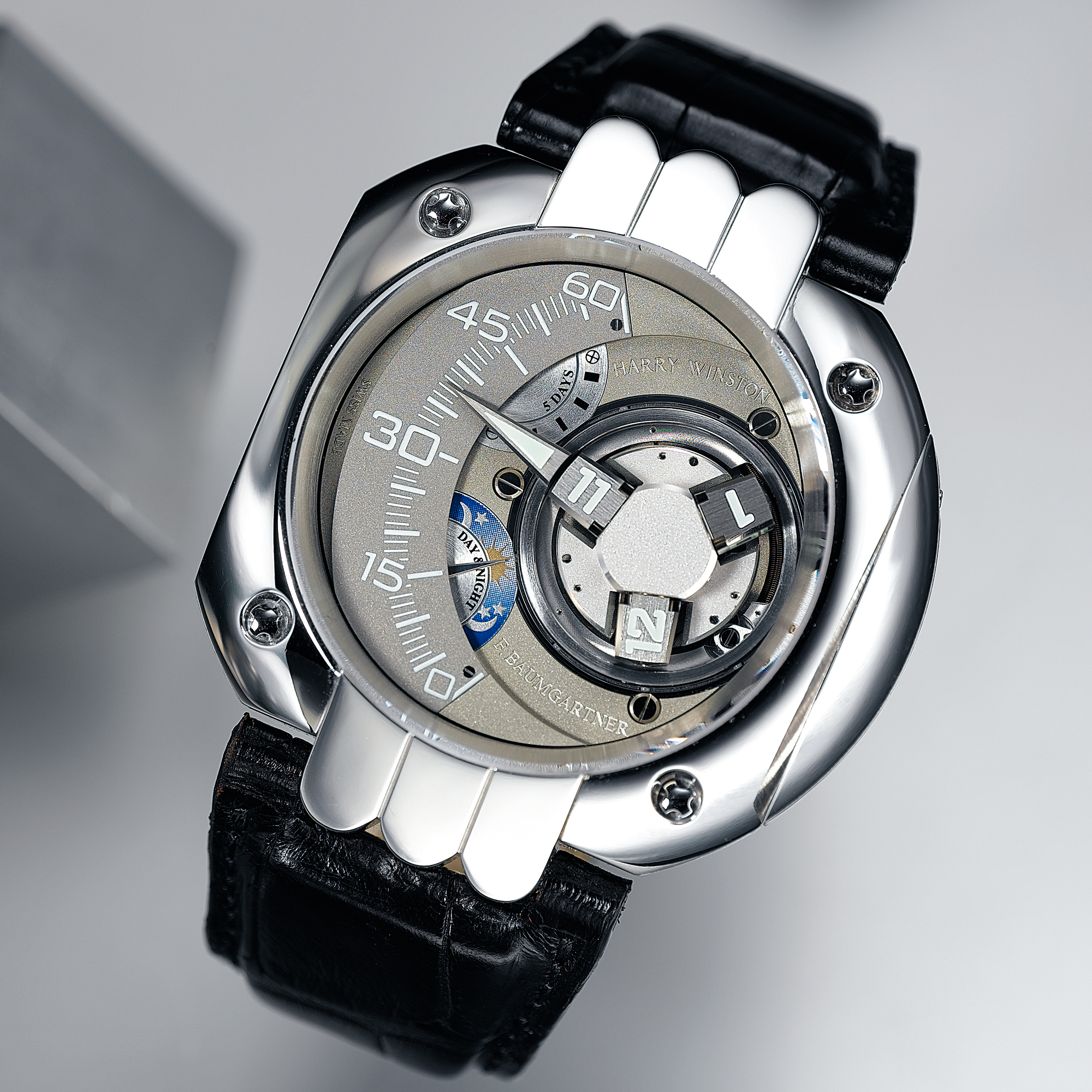 HARRY WINSTON, A FINE, RARE AND UNUSUAL LIMITED EDITION PLATINUM ASSYMETRIC WRISTWATCH WITH SATELLITE HOUR DISPLAY, RETROGRADE MINUTES, 5 DAYS POWER RESERVE, DAY/NIGHT AND 5-YEAR SERVICE INTERVAL INDICATION CIRCA 2005 OPUS V NO. 9/45 
 