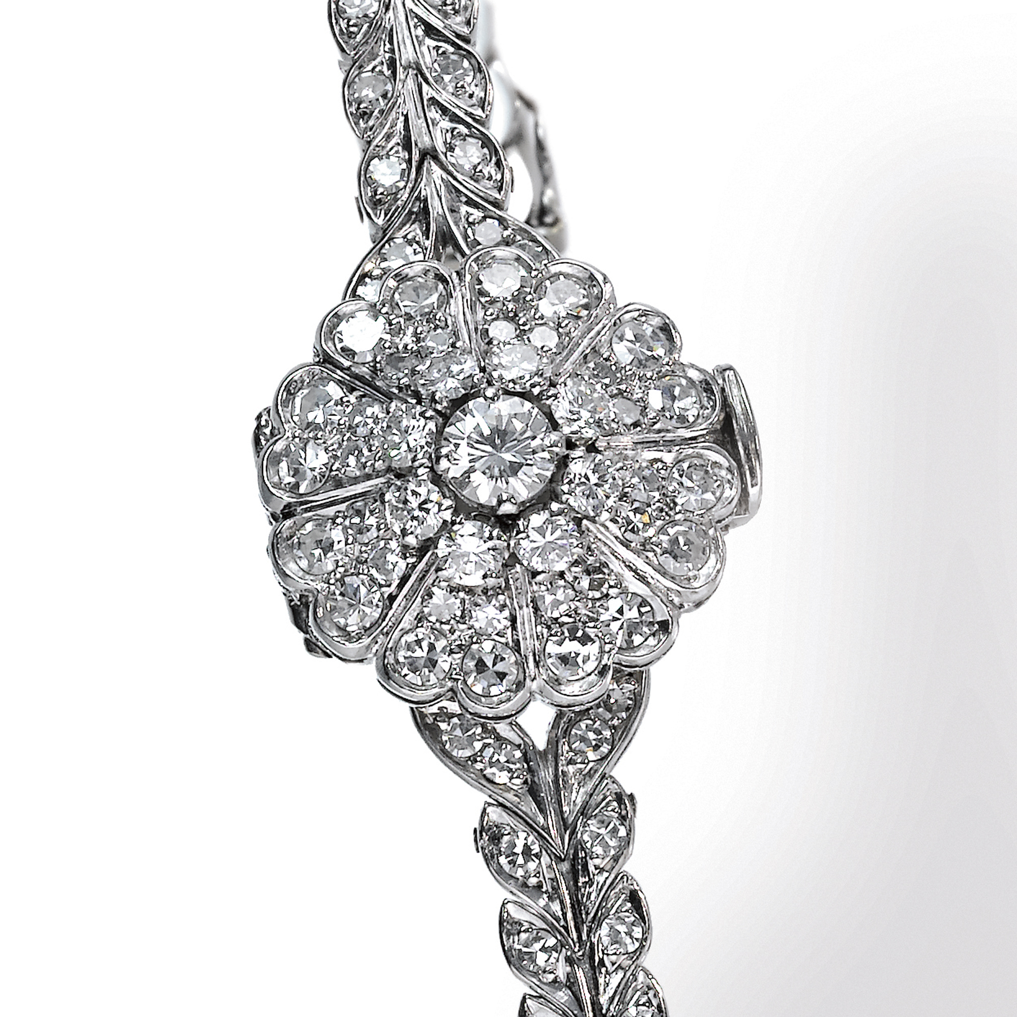 Omega, A LADY'S PLATINUM DIAMOND SET BRACELET WATCH WITH CONCEALED DIAL CIRCA 1990