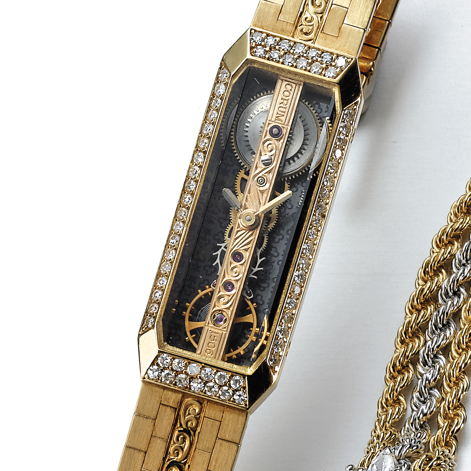 Corum, A GOLD AND DIAMOND-SET ELONGATED HEXAGONAL  SKELETIONISED LINEAR MOVEMENT BRACELET WATCH CIRCA 1990 GOLDEN BRIDGE