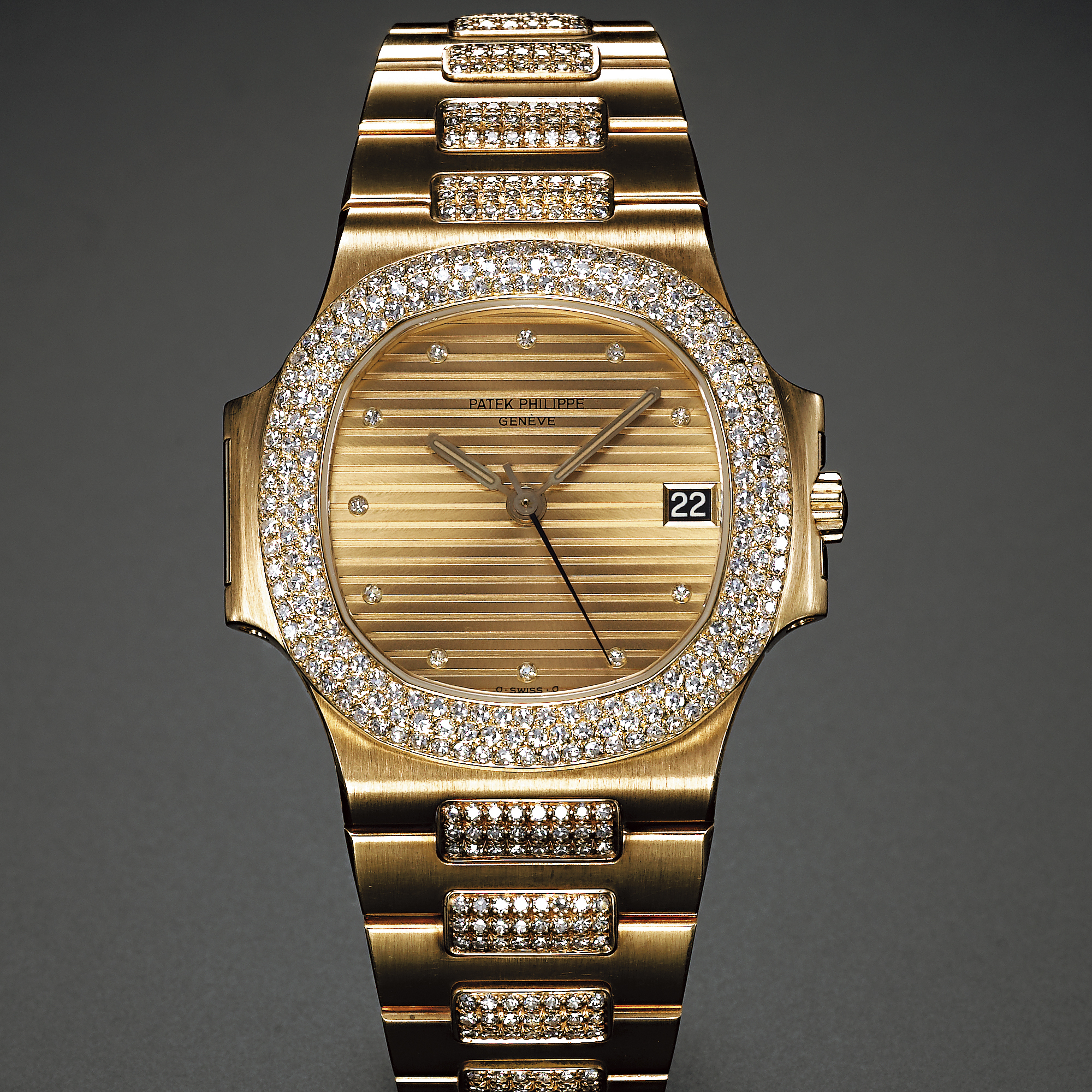 Patek Philippe, A GOLD AND DIAMOND SET AUTOMATIC CENTER SECONDS WRISTWATCH CIRCA 1985 REF 3800J NAUTILUS
