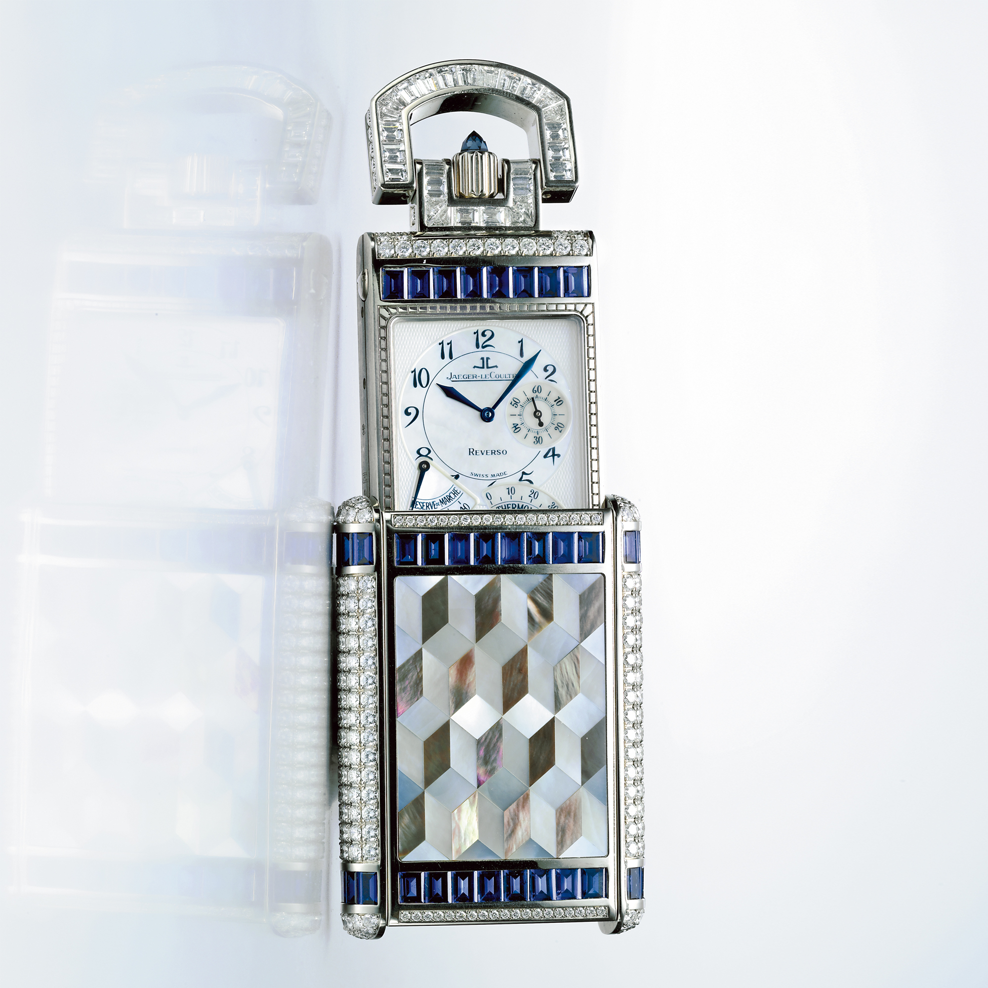 JAEGER-LECOULTRE, A VERY FINE AND RARE WHITE GOLD, DIAMOND AND SAPPHIRE SET RECTANGULAR REVERSIBLE TIMEPIECE WITH MOTHER-OF-PEARL DIAL, POWER RESERVE AND THERMOMETER INDICATION CIRCA 2004 REVERSO