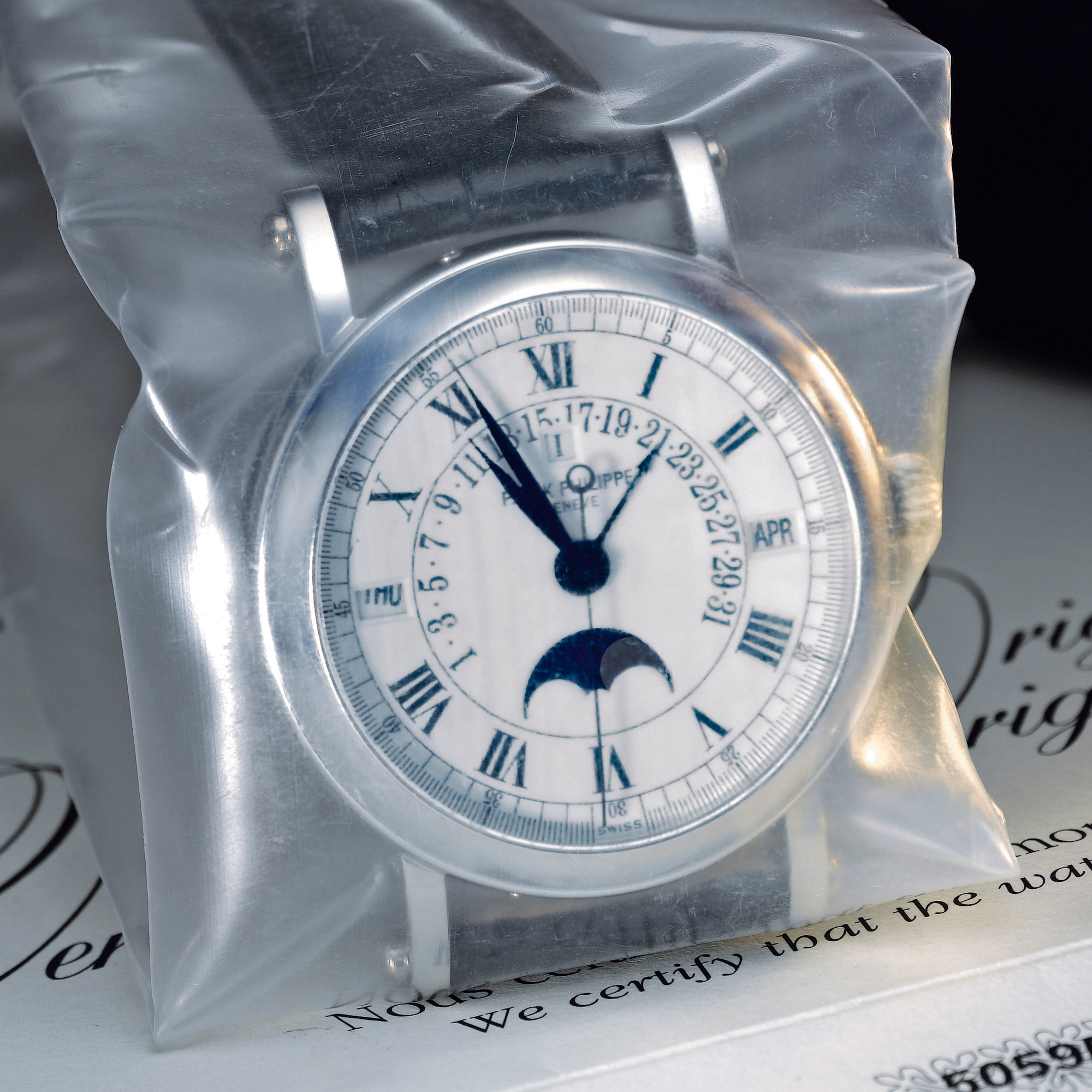 Patek Philippe, A FINE PLATINUM AUTOMATIC CENTER SECONDS PERPETUAL CALENDAR WRISTWATCH WITH RETROGRADE DATE AND MOON-PHASES AND LEAP YEAR INDICATION CIRCA 2003 REF 5059P MVT 3236515 CASE 4310025 