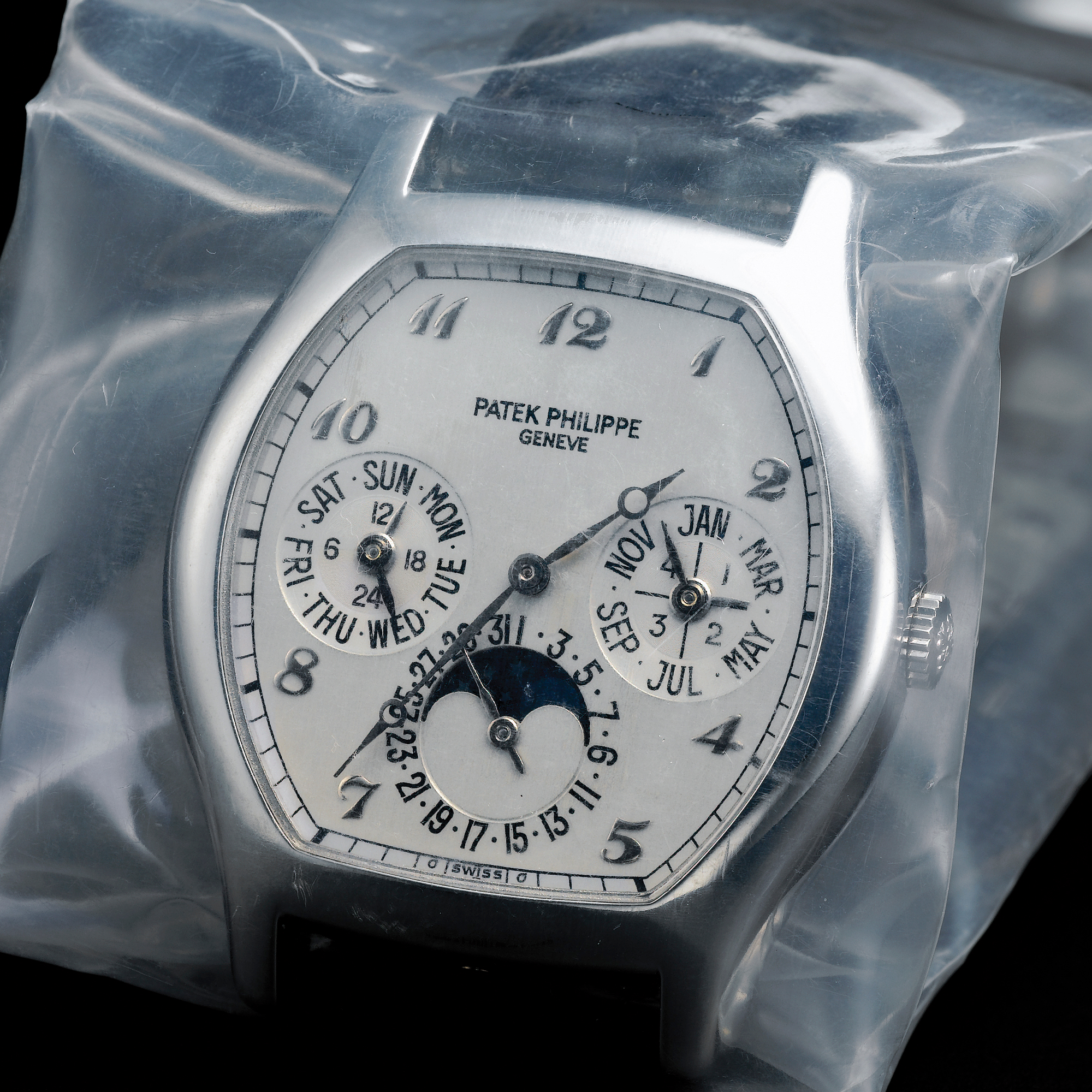Patek Philippe, A PLATINUM TONNEAU FORM AUTOMATIC PERPETUAL CALENDAR WRISTWATCH WITH MOON-PHASES AND LEAP YEAR INDICATION CIRCA 2005 REF 5040P MVT 3127639 CASE 4255199