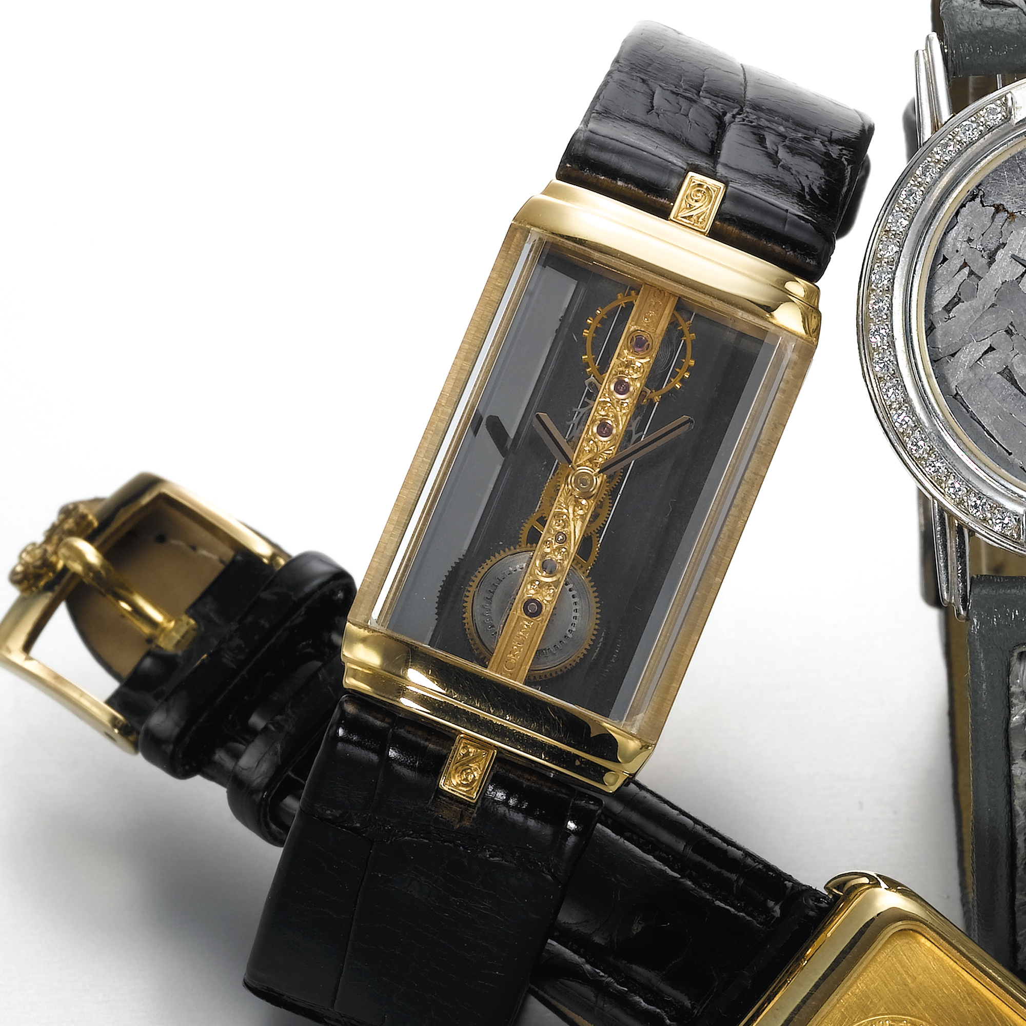 CORUM, A GOLD RECTANGULAR WRISTWATCH WITH SPECIAL LINEAR MOVEMENTGOLDEN BRIDGE, CIRCA 1990