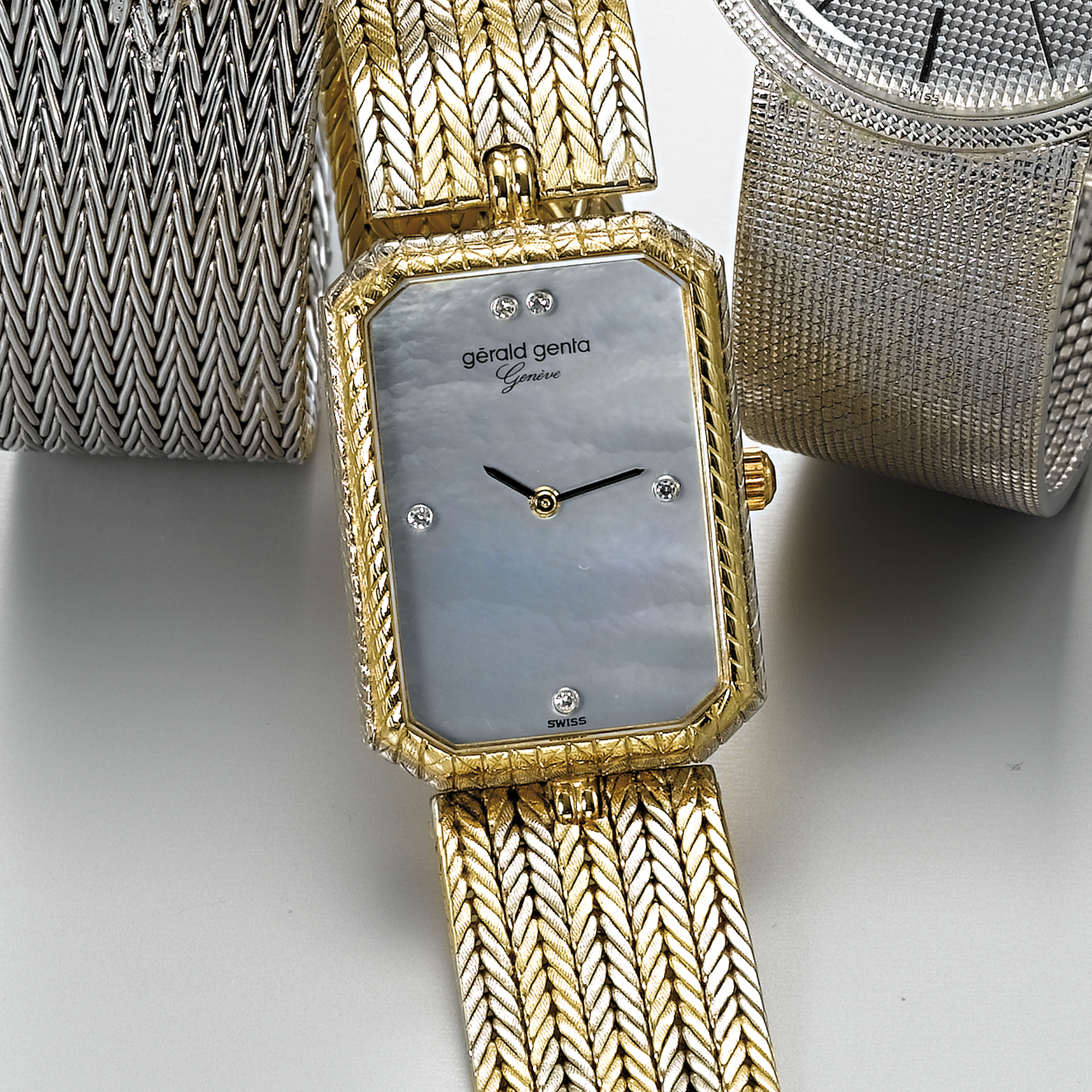 GERALD GENTA, A TWO-COLOUR GOLD AND DIAMOND SET RECTANGULAR BRACELET WATCH WITH MOTHER-OF-PEARL DIALCIRCA 1990