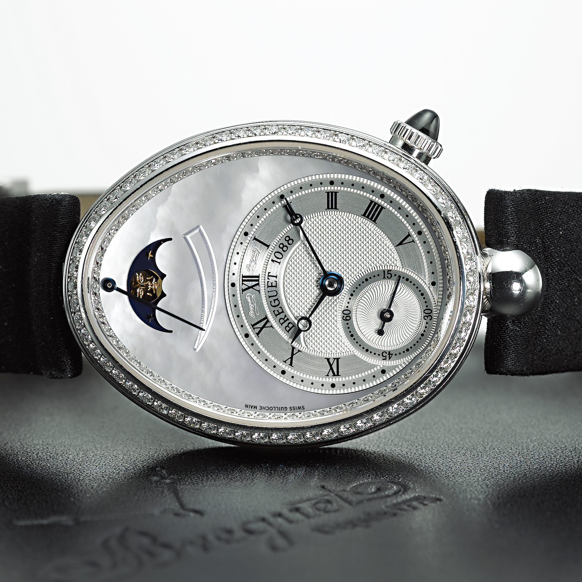 BREGUET, A LADY'S FINE WHITE GOLD AUTOMATIC WRISTWATCH WITH POWER RESERVE, MOON PHASES AND MOTHER-OF-PEARL DIALREINE DE NAPLES, CIRCA 2005, 1088P, NO. 0015657, REF. 8908