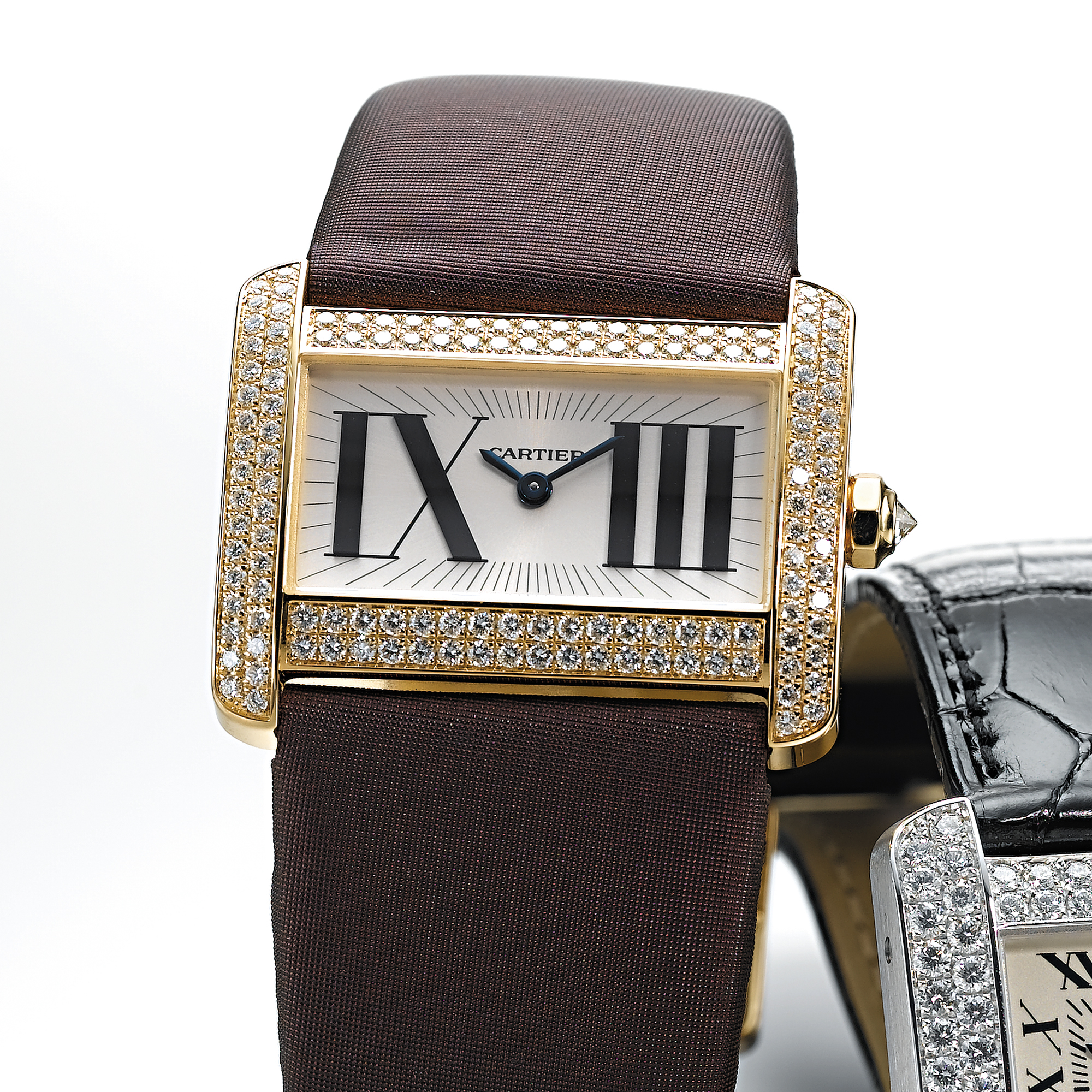 CARTIER, A LADY'S GOLD AND DIAMOND SET RECTANGULAR WRISTWATCHTANK DIVAN, CIRCA 2005