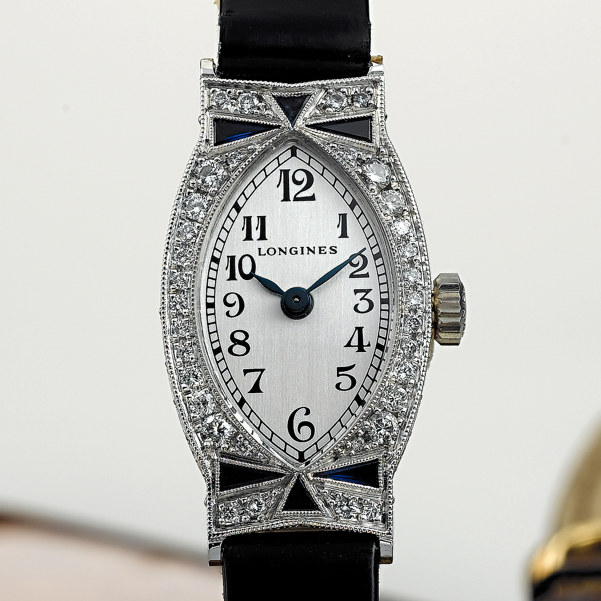 LONGINES, A LADY'S WHITE GOLD, SAPPHIRE AND DIAMOND SET ELONGATED TONNEAU FORM WRISTWATCHLES ELEGANTES, CIRCA 2002