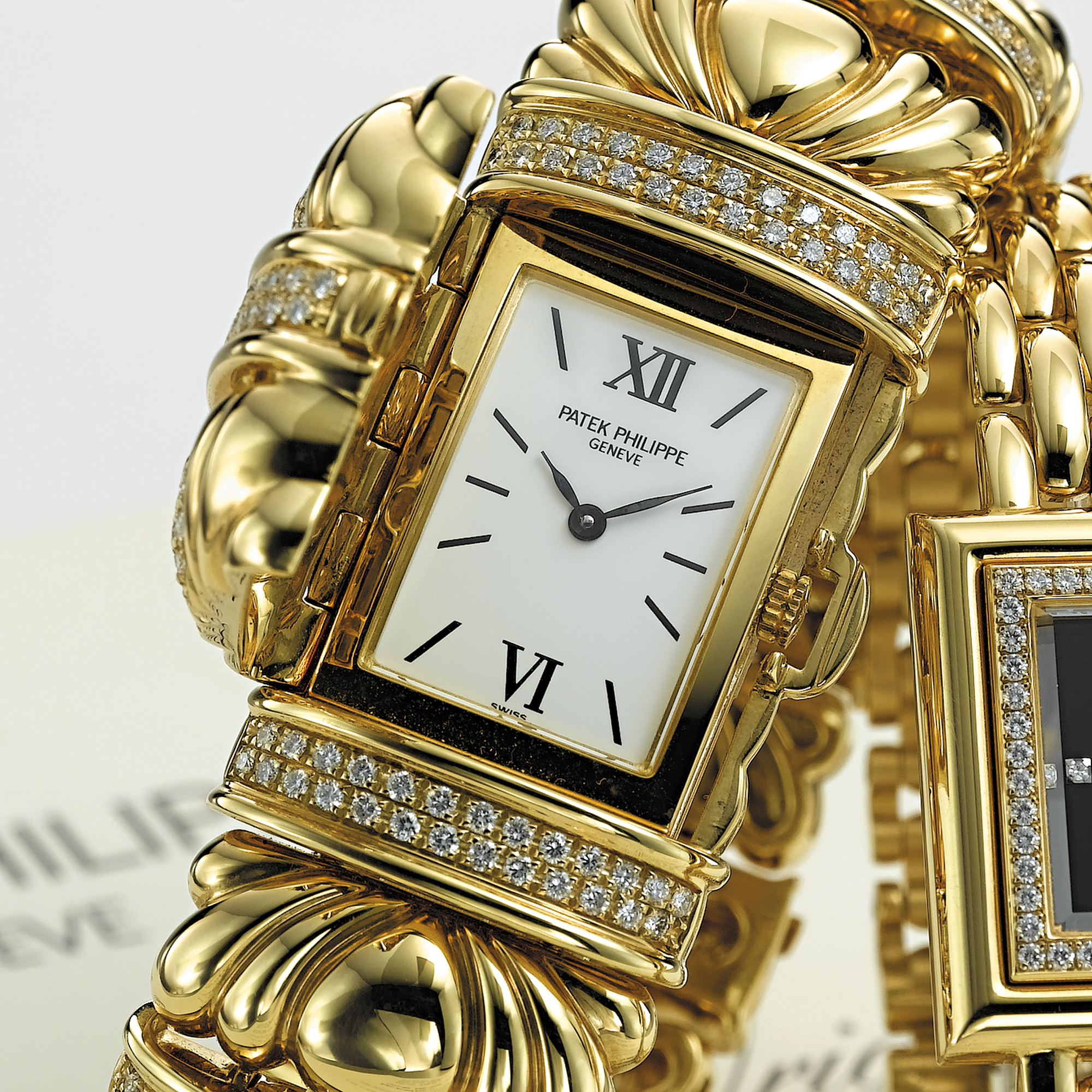PATEK PHILIPPE, A LADY'S GOLD AND DIAMOND SET BRACELET WATCH WITH CONCEALED DIALCIRCA 2002, NO. 1.970.408, REF. 4955