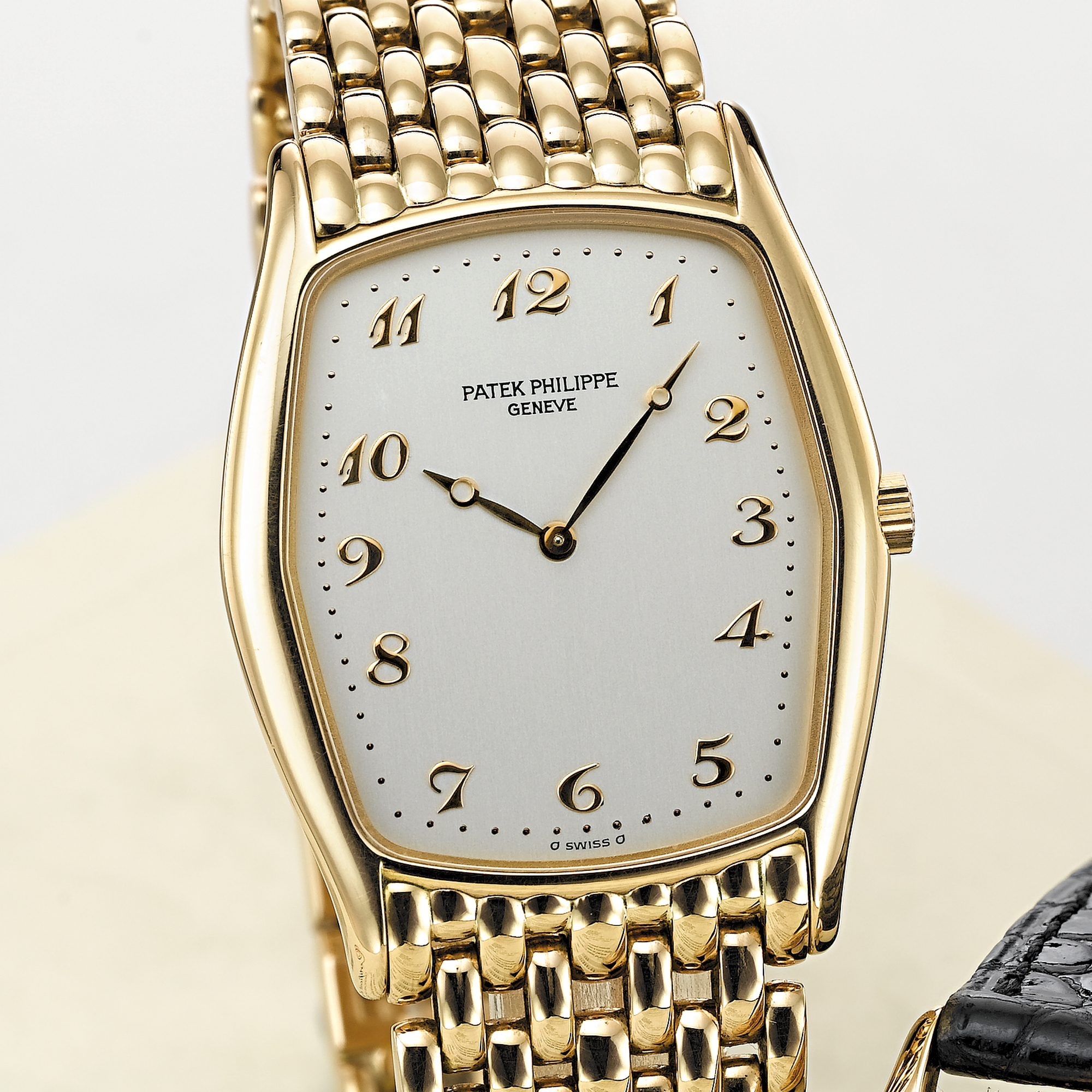 PATEK PHILIPPE, A PINK GOLD TONNEAU WRISTWATCH WITH BRACELETCIRCA 1996, NO. 1.377.918, REF. 3842
