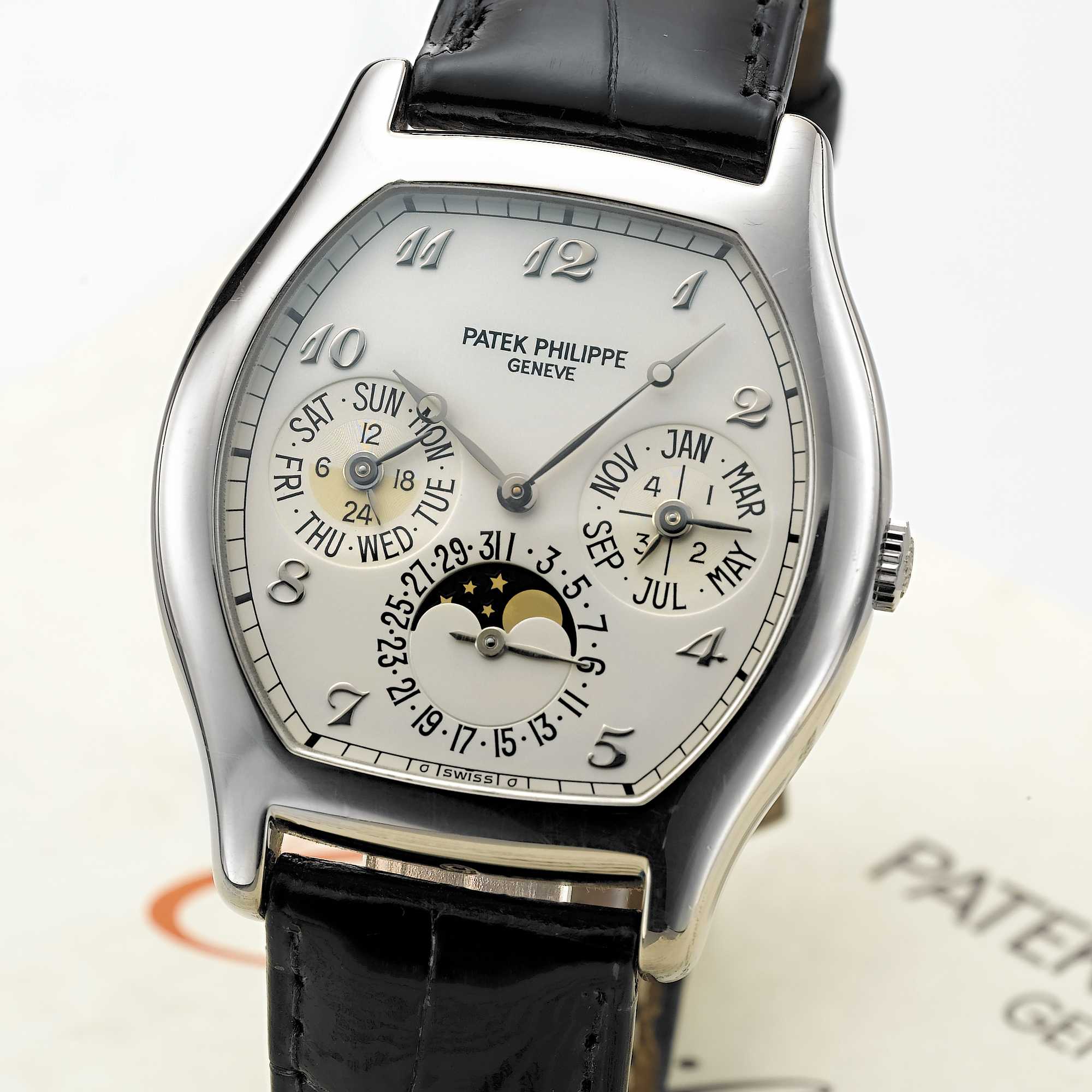 PATEK  PHILIPPE, A FINE WHITE GOLD TONNEAU AUTOMATIC PERPETUAL CALENDAR WRISTWATCH WITH MOON PHASESCIRCA 2000, NO. 774.817, REF. 5040