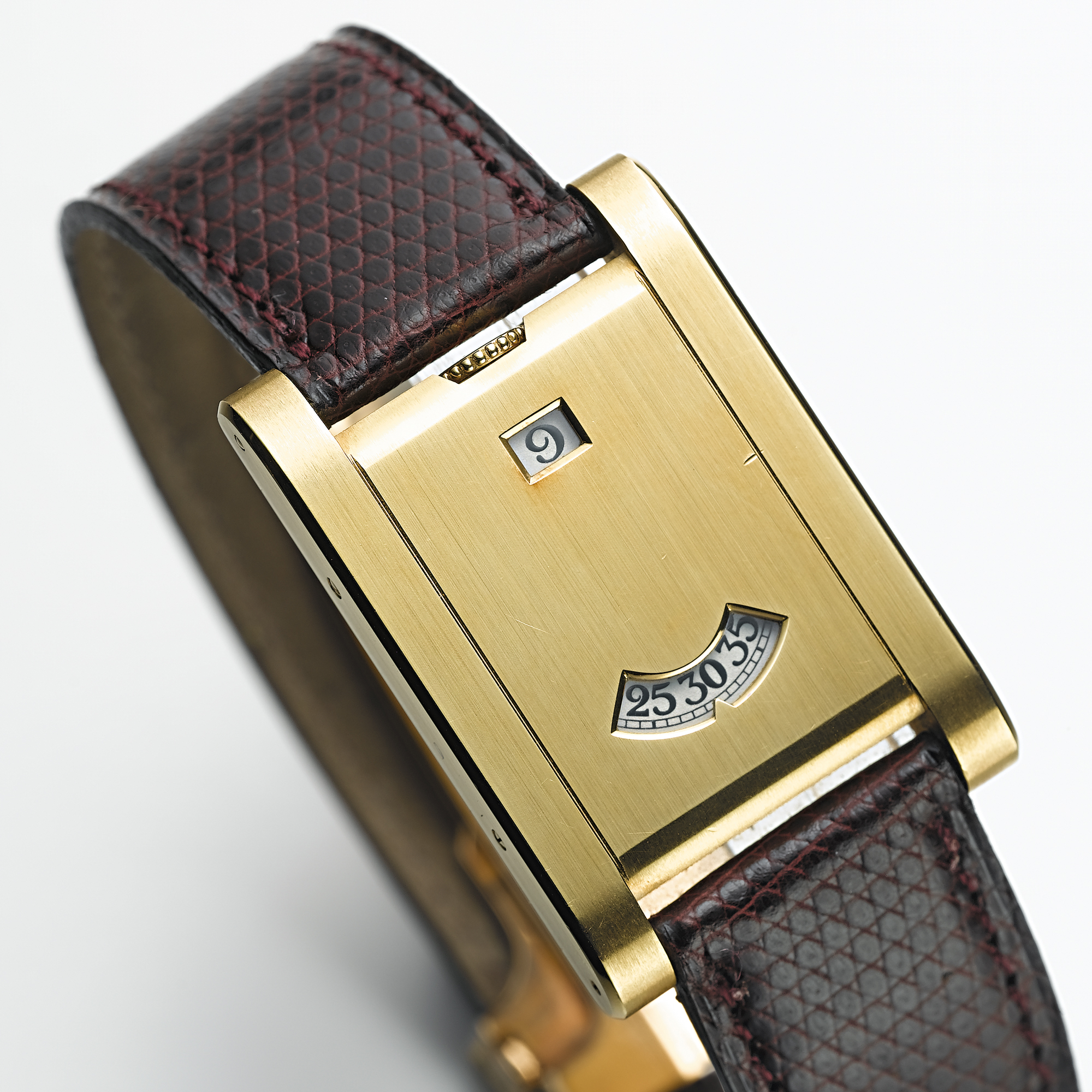 CARTIER, A RARE LIMITED EDITION GOLD RECTANGULAR JUMPING HOUR WRISTWATCHTANK A GUICHETS, CIRCA 1996, 1/3