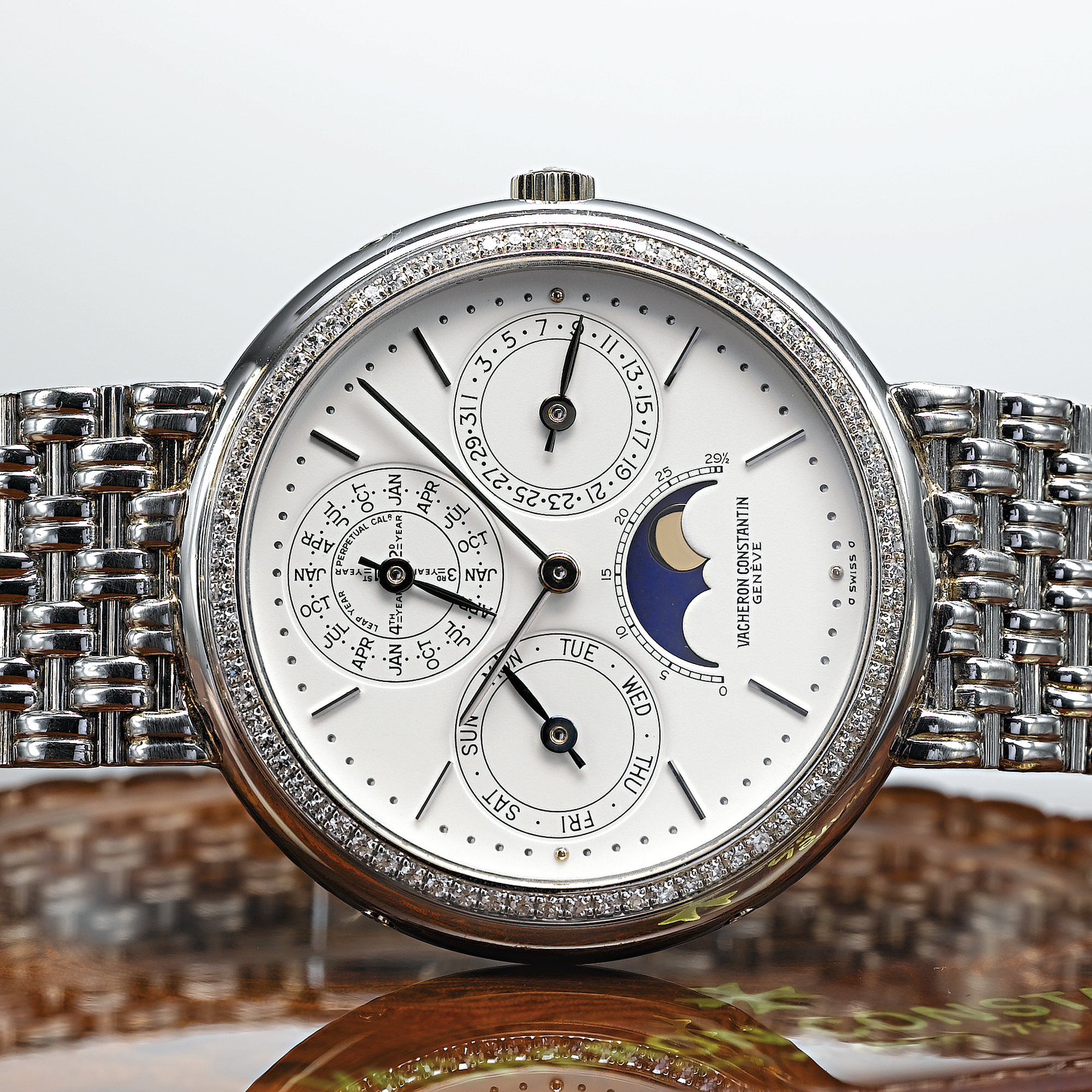 VACHERON CONSTANTIN, A PLATINUM AND DIAMOND SET AUTOMATIC PERPETUAL CALENDAR BRACELET WATCH WITH MOON PHASESCIRCA 1995