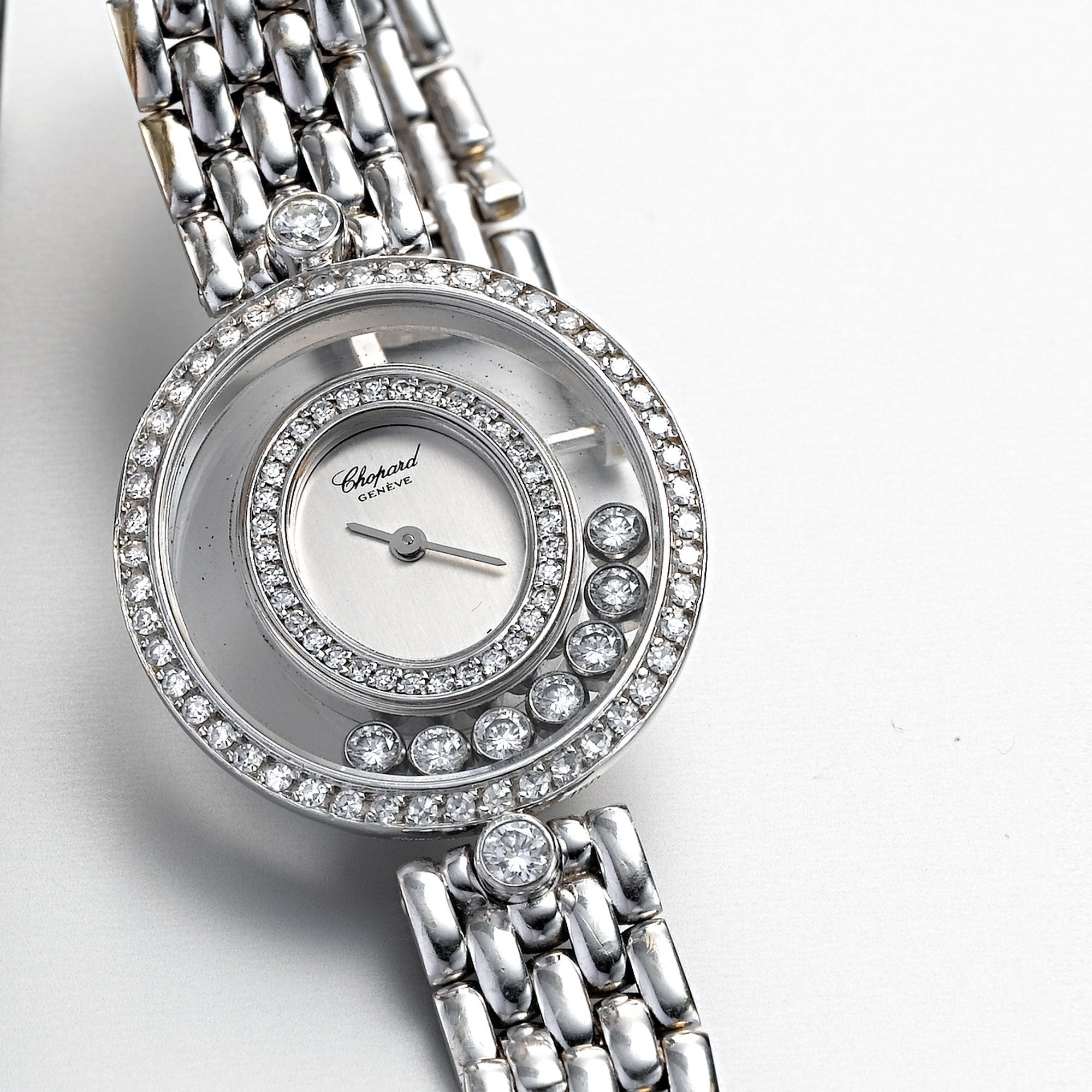 CHOPARD, A LADY'S WHITE GOLD AND DIAMOND SET OVAL WRISTWATCH WITH BRACELETHAPPY DIAMONDS, CIRCA 1994