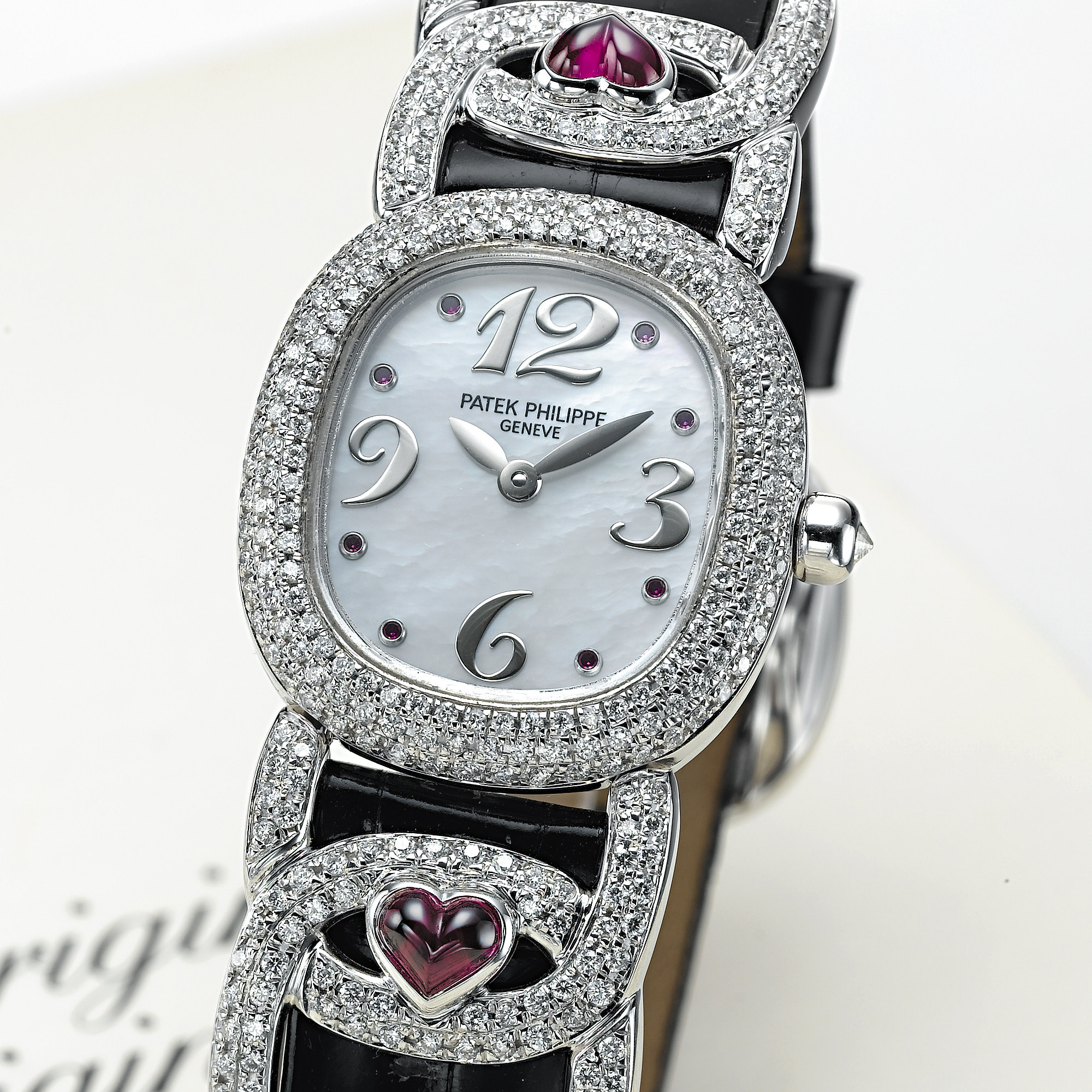 PATEK PHILIPPE, A LADY'S WHITE GOLD AND RUBY SET OVAL WRISTWATCH WITH MOTHER-OF-PEARL DIAL AND LATER ADDED DIAMONDSGOLDEN ELLIPSE, CIRCA 1998, REF. 4833/12