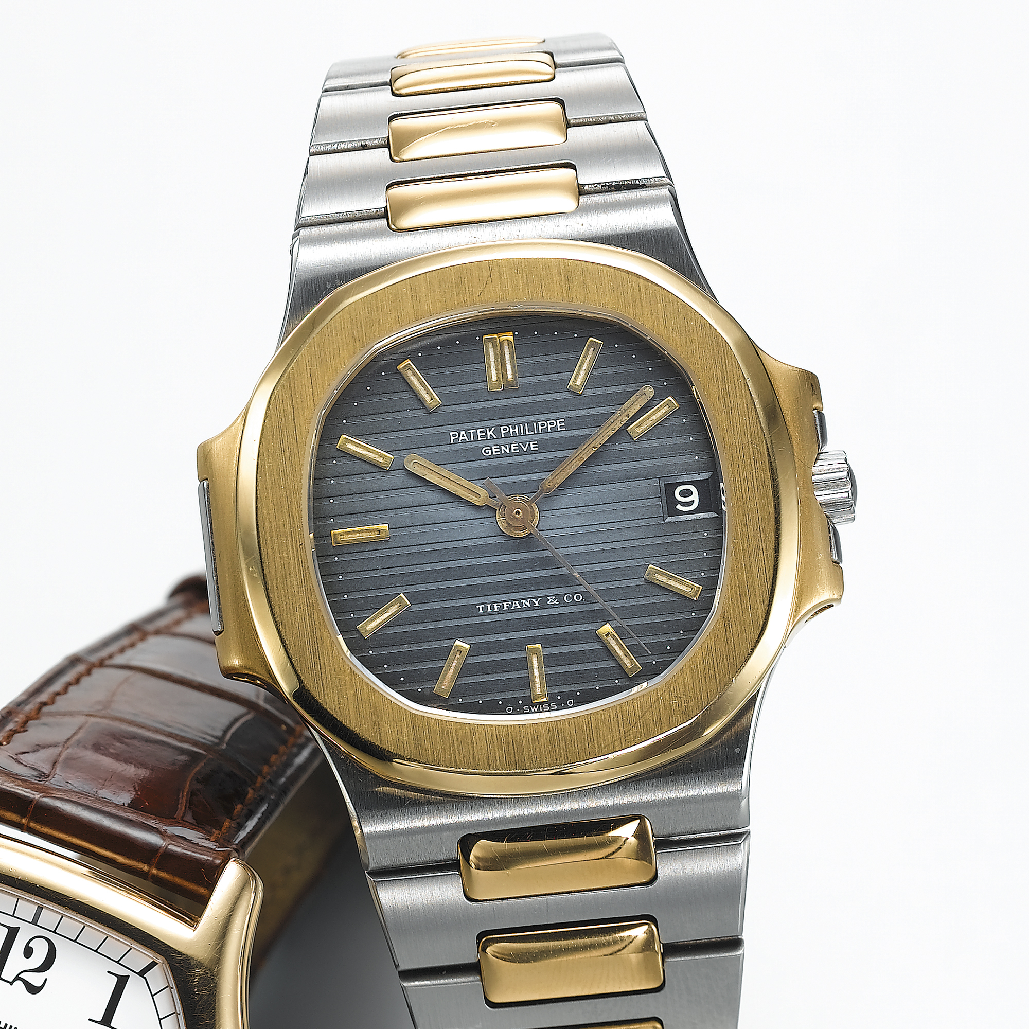 PATEK PHILIPPE, A MID SIZE GOLD AND STAINLESS STEEL CUSHION FORM AUTOMATIC CENTRE WRISTWATCH BRACELET WATCH WITH DATERETAILED BY TIFFANY & CO., NAUTILUS, CIRCA 1995, REF. 3900